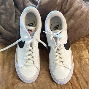 Nike White Sneakers with Black Swoosh and Tan Accent